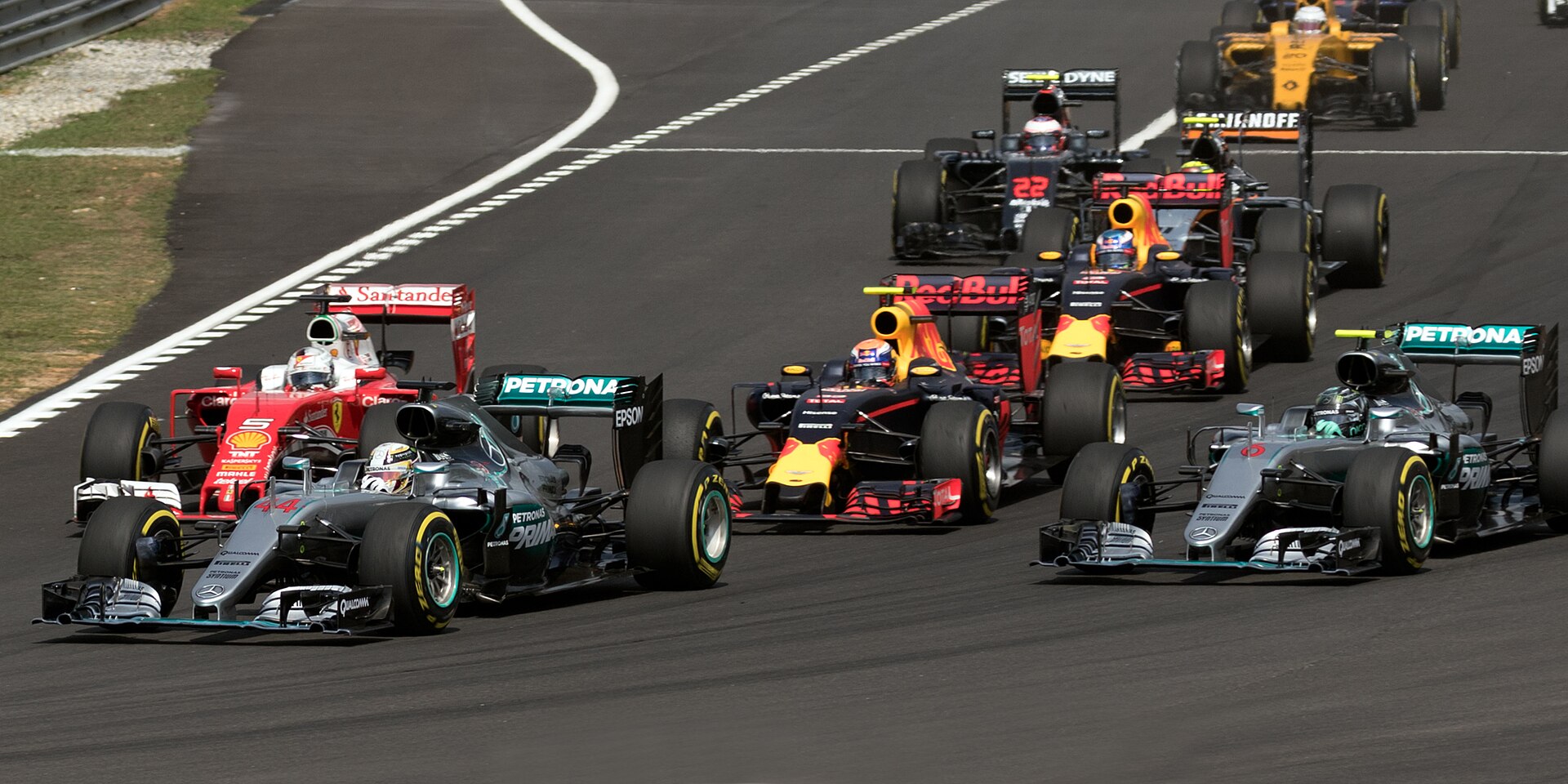 Formula 1 cars racing into the first corner at Sepang in 2016